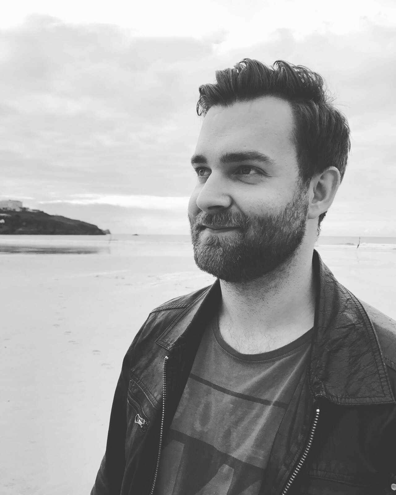 Martin, B&W, beach, leather jacket, looking off-camera